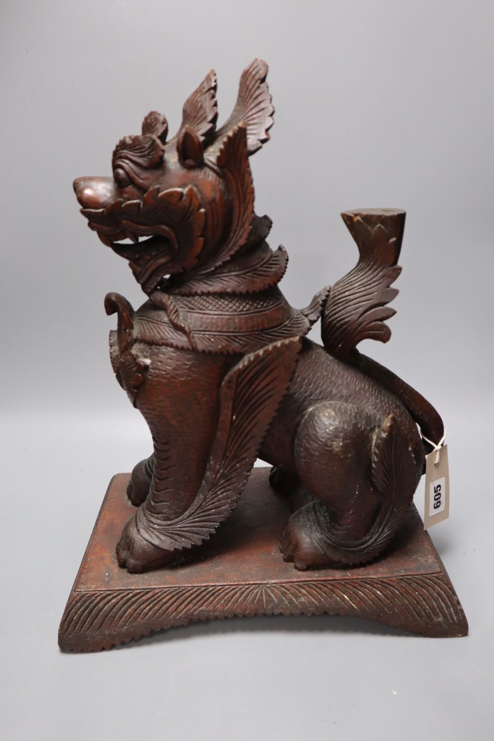 An Indonesian large carved wood model of a seated kylin, on plinth base and two Chinese rootwood carvings of elders, H approx 44cm (kyl